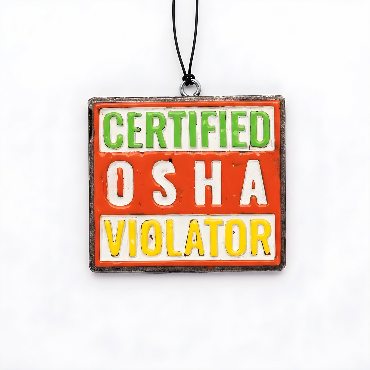 A square novelty sign with a black hanging cord, featuring the text 'CERTIFIED OSHA VIOLATOR' in green, white, and yellow lettering on a red-orange background.