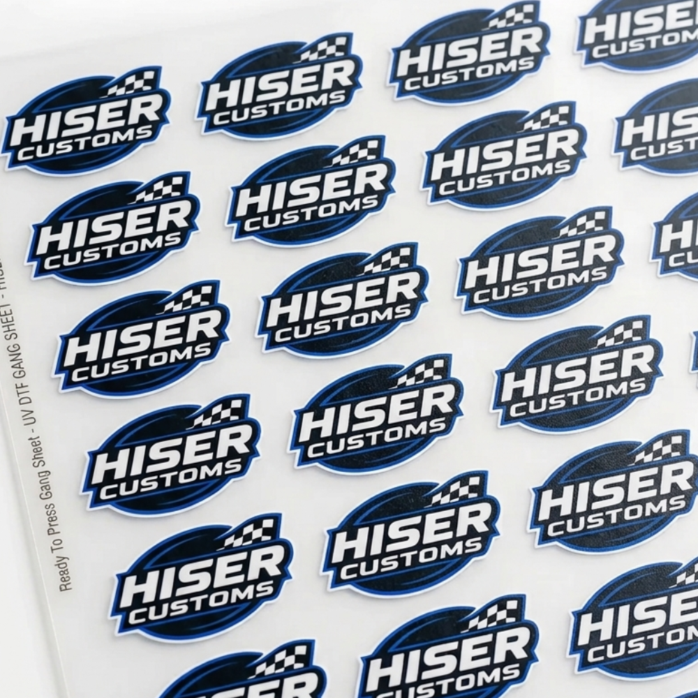 A sheet of repeated Hiser Customs logo decals or stickers on a white backing, photographed at a slight angle on a white background.