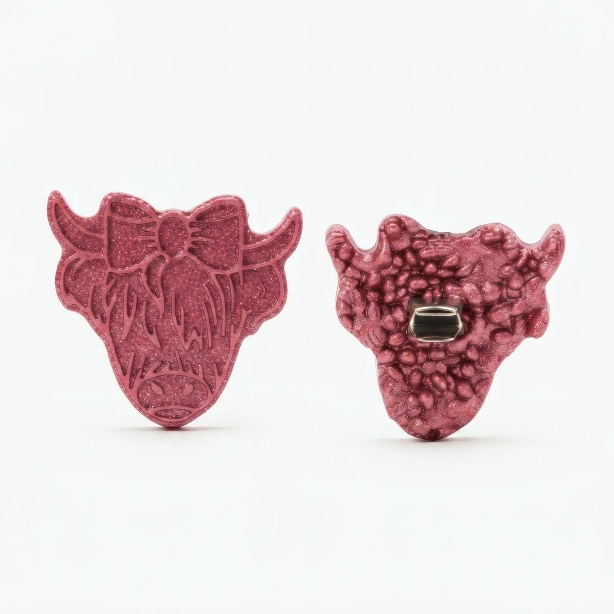 A pair of textured, pinkish-red cow head stud earrings shown from both the front and back views on a clean white background.
